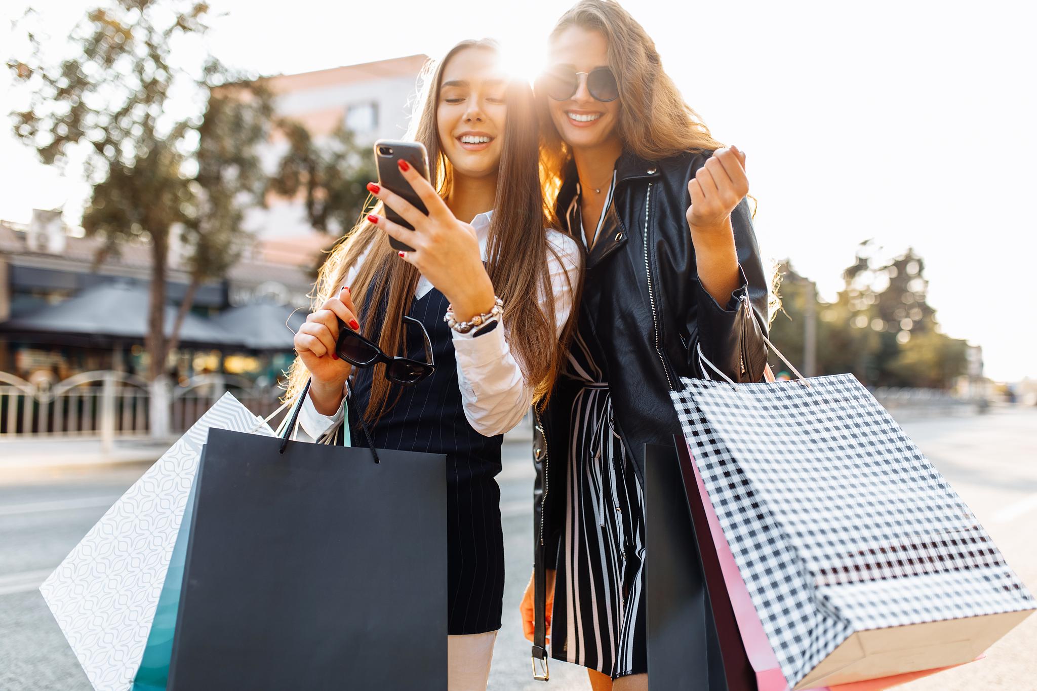Smiling woman holding a gift box, illustrating how to reward brand advocates with thoughtful recognition