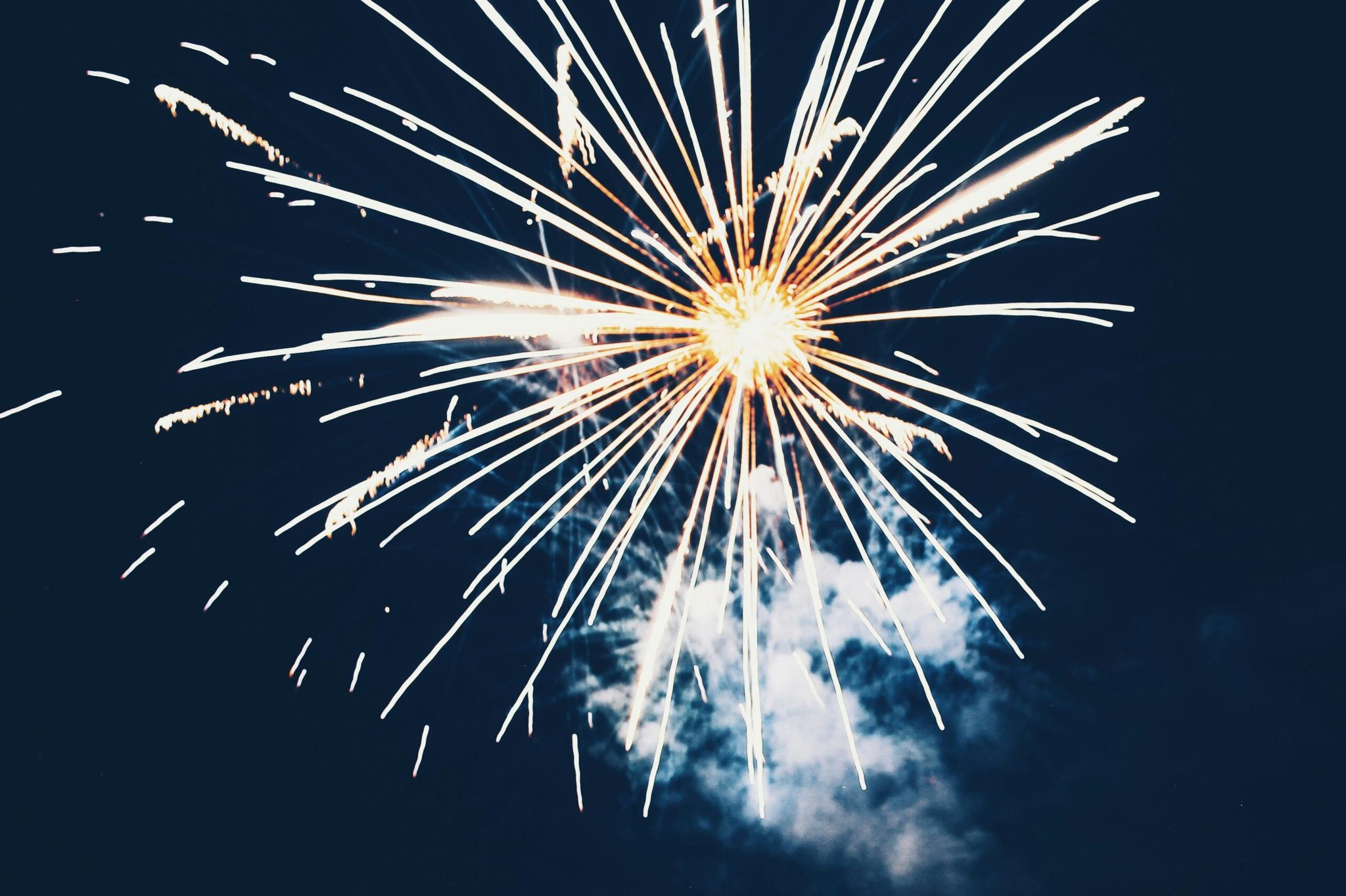 A bright firework burst against a dark night sky, representing a referral contest celebration.