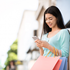 Woman smiling carrying her shopping bags