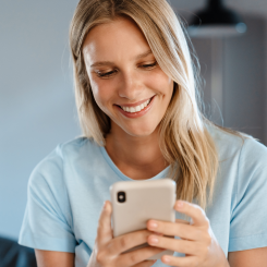 woman smiling on her phone