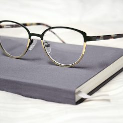 close up shot of a pair of eyeglasses on top of a notebook